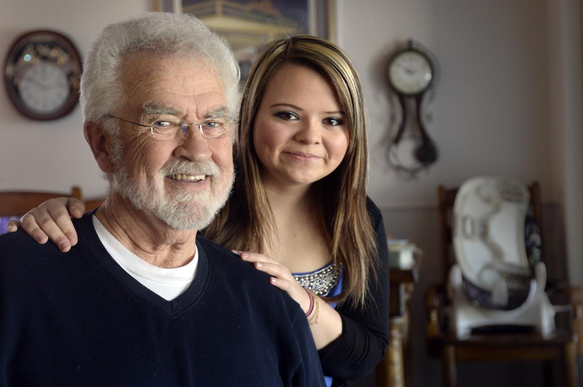 Morgan standing behind grandfather